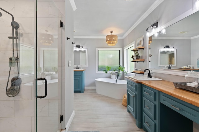 1858 Stoney Brook Ct, Conroe, TX 77304 - bathroom with two vanities, a stall shower, wood finished floors, ornamental molding, and a freestanding bath