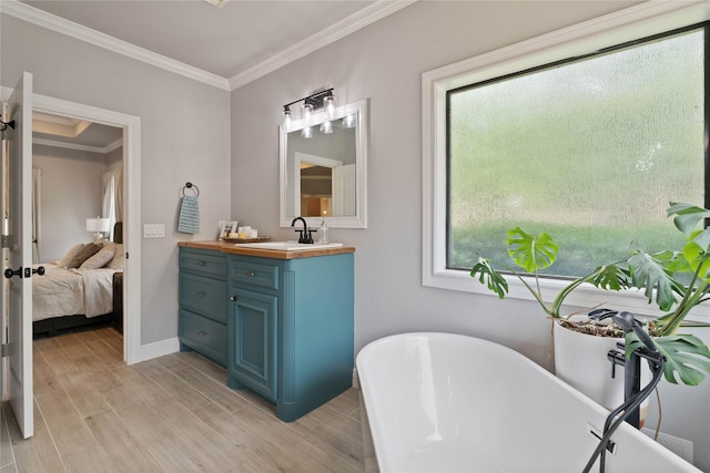 1858 Stoney Brook Ct, Conroe, TX 77304 - bathroom featuring vanity, crown molding, a soaking tub, wood finished floors, and ensuite bath