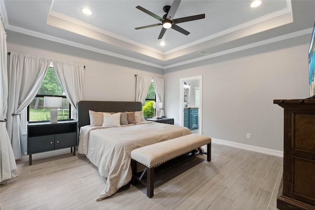 1858 Stoney Brook Ct, Conroe, TX 77304 - bedroom featuring a tray ceiling, light wood-style floors, baseboards, connected bathroom, and crown molding