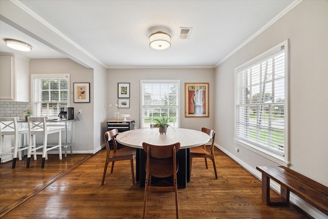6402 Brookside Dr, Houston, TX 77023 - dining space featuring ornamental molding, dark wood-style flooring, and baseboards