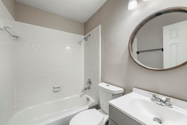 full bathroom with a textured wall, bathing tub / shower combination, vanity, and toilet