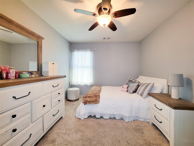 bedroom featuring visible vents, light colored carpet, and ceiling fan