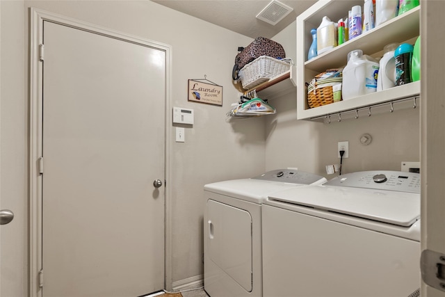 laundry area with independent washer and dryer, visible vents, and laundry area