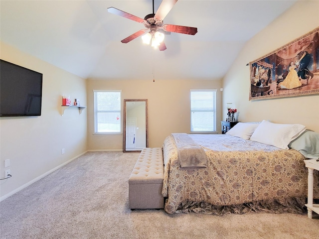 carpeted bedroom featuring baseboards, a ceiling fan, and vaulted ceiling