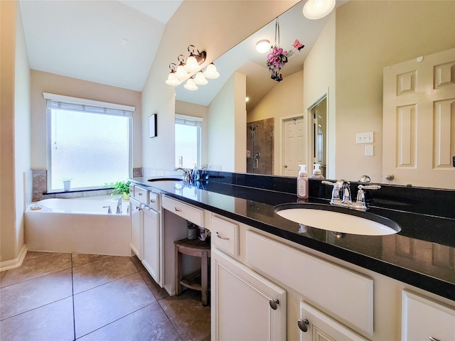 bathroom featuring a sink, tile patterned floors, a shower stall, and lofted ceiling
