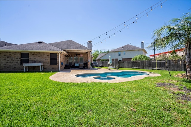 view of swimming pool with a fenced backyard, ceiling fan, a patio, and a lawn