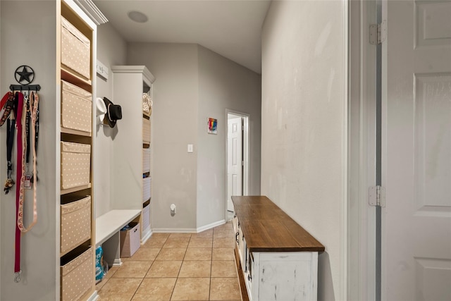 mudroom featuring light tile patterned floors and baseboards