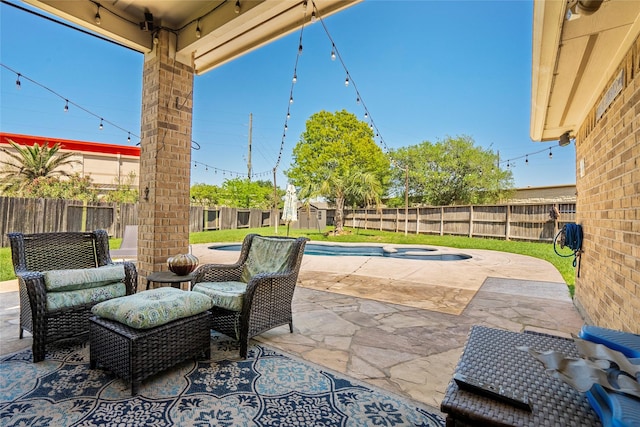 view of patio featuring a fenced backyard and a pool with connected hot tub