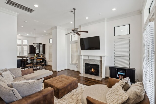 1427 Shearn St, Houston, TX 77007 - living area with ornamental molding, visible vents, a fireplace with flush hearth, and dark wood-style flooring