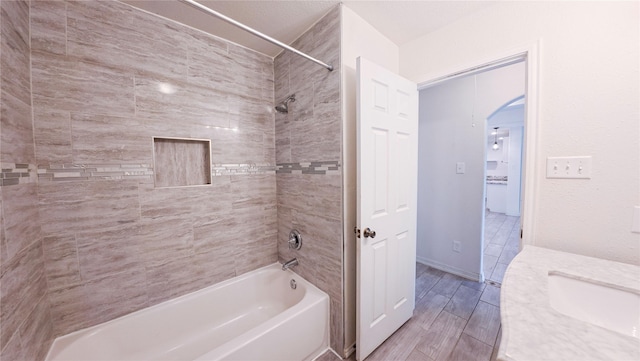 bathroom featuring wood tiled floor and shower / bathtub combination