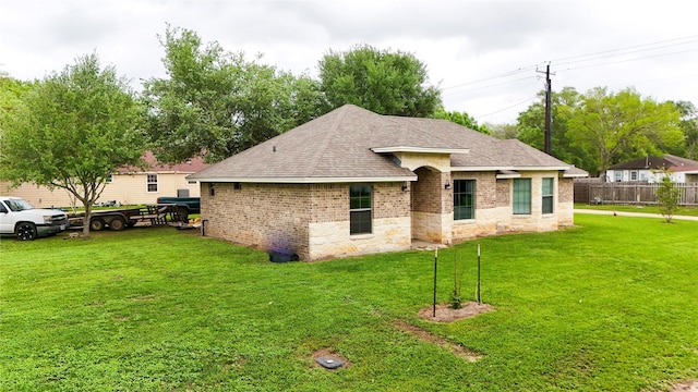 ranch-style house with brick siding and a front lawn