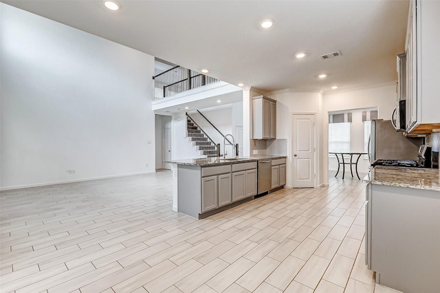 3007 Velda May Dr, Richmond, TX 77406 - kitchen featuring visible vents, appliances with stainless steel finishes, recessed lighting, light stone countertops, and gray cabinets