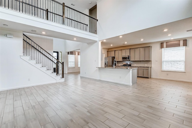 3007 Velda May Dr, Richmond, TX 77406 - kitchen with open floor plan, appliances with stainless steel finishes, and light wood finished floors