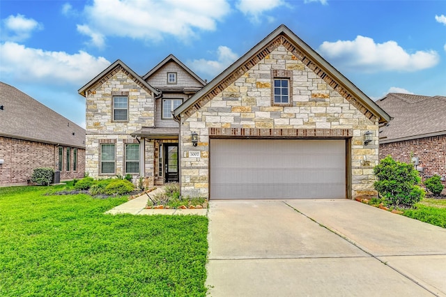 3007 Velda May Dr, Richmond, TX 77406 - view of front facade with a front lawn, stone siding, and driveway