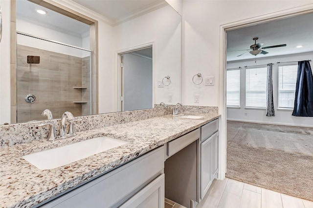 3007 Velda May Dr, Richmond, TX 77406 - bathroom with tiled shower, a sink, ornamental molding, and ceiling fan