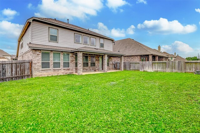 3007 Velda May Dr, Richmond, TX 77406 - back of house featuring brick siding, a fenced backyard, a patio, and a lawn