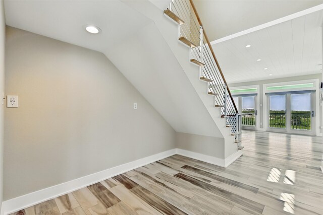 4102 Kiva Rd, Galveston, TX 77554 - staircase featuring baseboards, recessed lighting, wood finished floors, and lofted ceiling