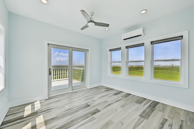 4102 Kiva Rd, Galveston, TX 77554 - spare room featuring ceiling fan, light wood-type flooring, recessed lighting, an AC wall unit, and baseboards