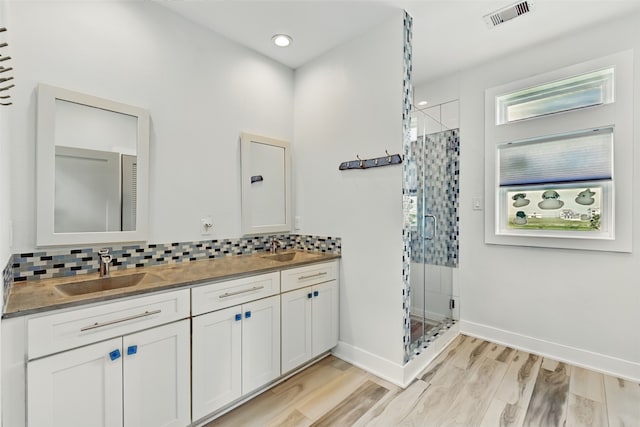 4102 Kiva Rd, Galveston, TX 77554 - full bathroom with visible vents, a sink, and backsplash