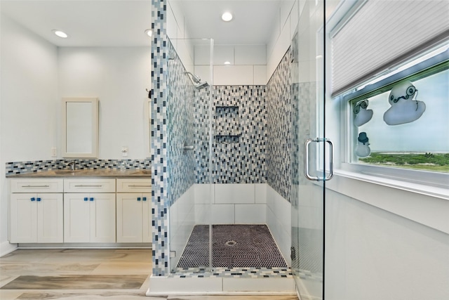 4102 Kiva Rd, Galveston, TX 77554 - bathroom featuring a shower stall, vanity, and backsplash