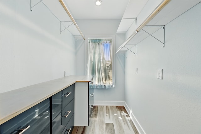 4102 Kiva Rd, Galveston, TX 77554 - walk in closet featuring wood finished floors