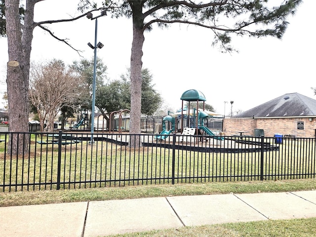 communal playground with a yard and fence