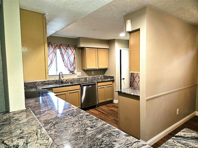kitchen featuring baseboards, a sink, dark countertops, dark wood finished floors, and stainless steel dishwasher