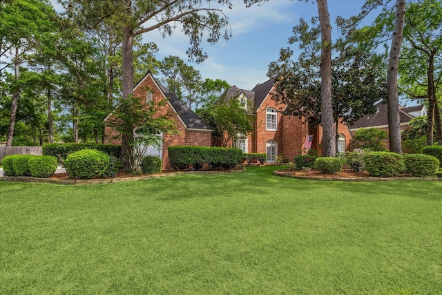 view of front of property with a front yard and brick siding