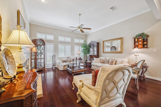 living area featuring baseboards, a ceiling fan, crown molding, visible vents, and wood-type flooring