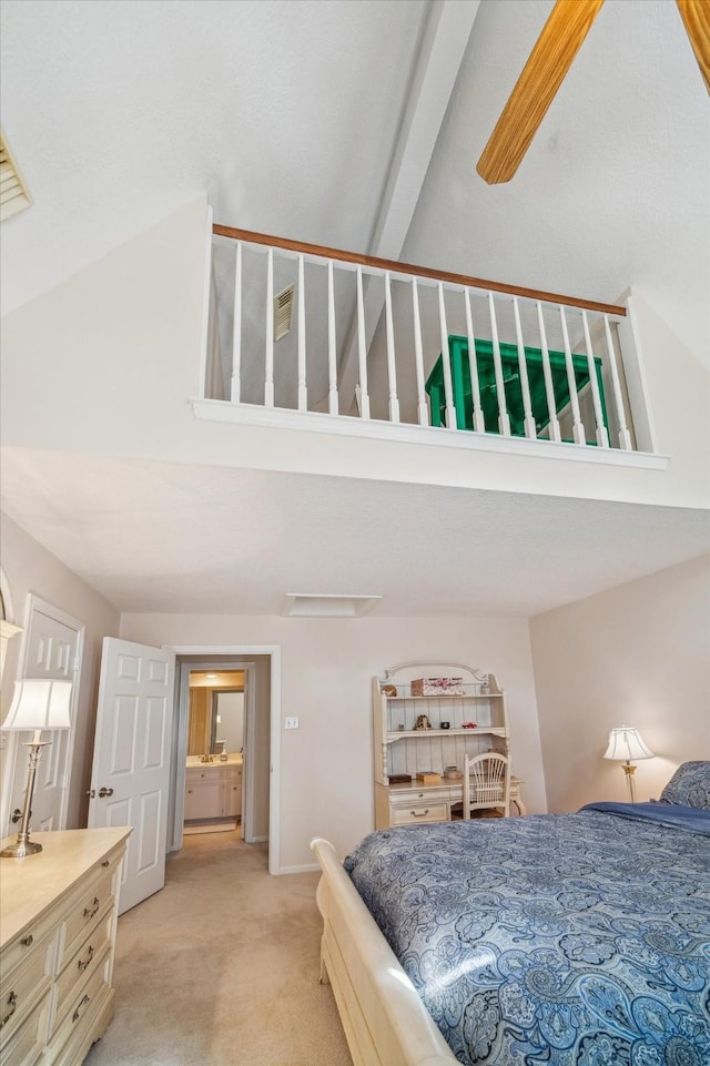 carpeted bedroom with a high ceiling and baseboards