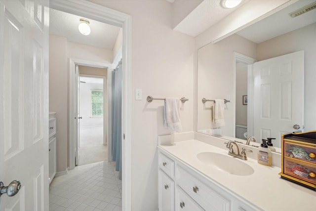 bathroom with tile patterned flooring, vanity, visible vents, and toilet