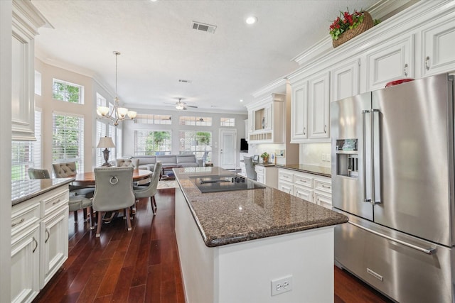 kitchen featuring high end refrigerator, open floor plan, black electric cooktop, and dark wood finished floors