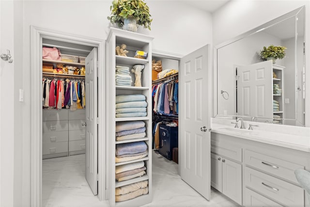 1906 Riverglen Forest Dr, Kingwood, TX 77345 - full bathroom with marble finish flooring, vanity, and a walk in closet