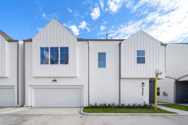 845 Elkhart St Unit C, Houston, TX 77091 - view of front of property with board and batten siding, an attached garage, and driveway