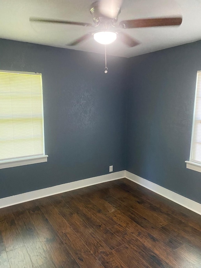 unfurnished room featuring ceiling fan, baseboards, and dark wood-style floors