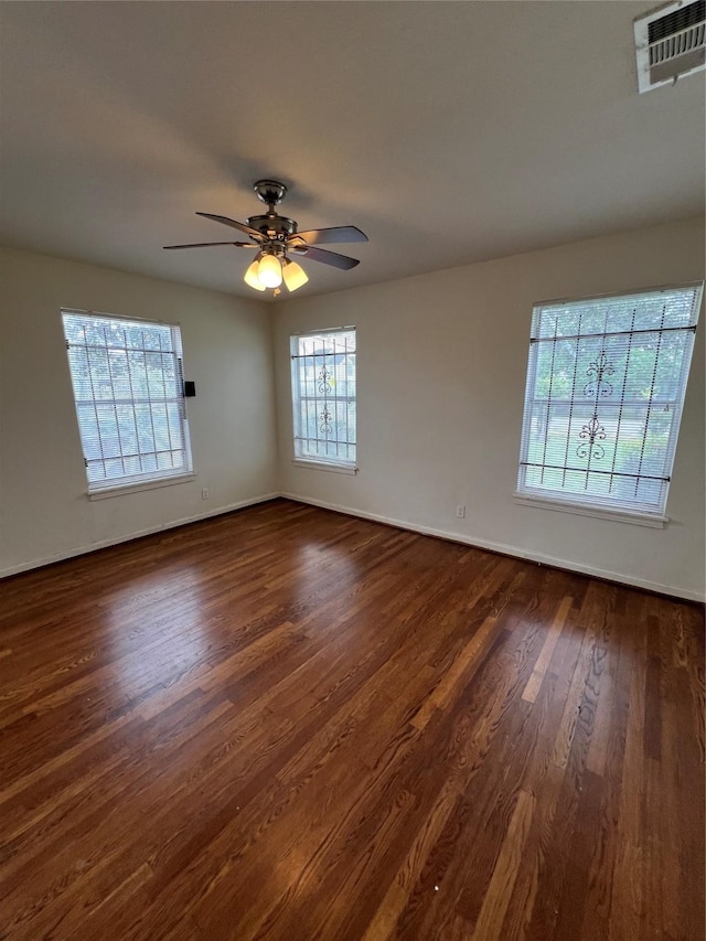 206 W 44th St, Houston, TX 77018 - empty room featuring a ceiling fan, dark wood-style floors, visible vents, and plenty of natural light