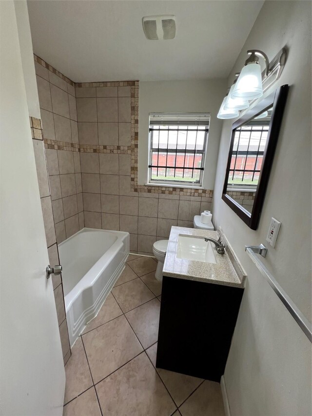 206 W 44th St, Houston, TX 77018 - bathroom with visible vents, tile walls, toilet, vanity, and tile patterned flooring