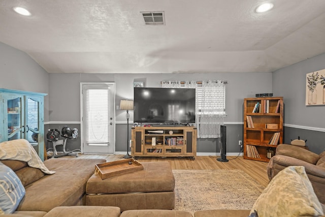living area with vaulted ceiling, wood finished floors, recessed lighting, and baseboards