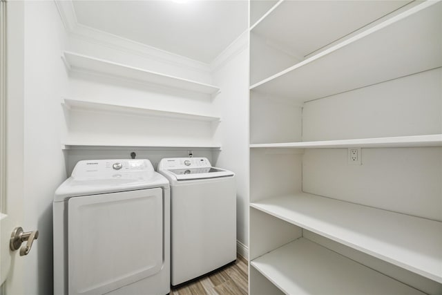 2510 Cobble Ridge Dr, Sugar Land, TX 77498 - laundry area with washer and dryer, light wood-style floors, and ornamental molding