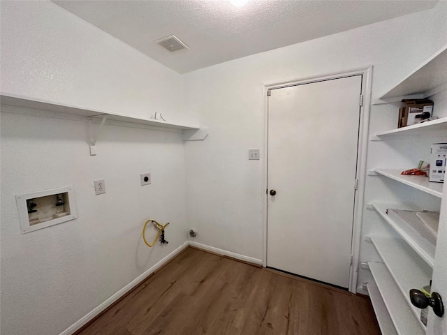 clothes washing area featuring laundry area, wood finished floors, gas dryer hookup, hookup for a washing machine, and electric dryer hookup