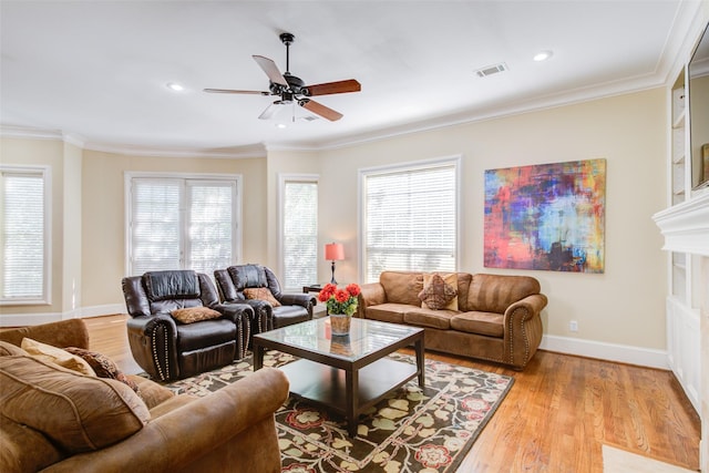 living area with a ceiling fan, baseboards, visible vents, and light wood-style flooring