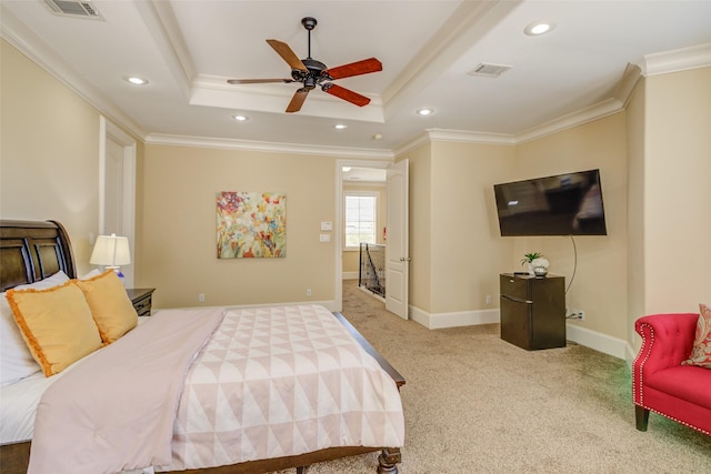 carpeted bedroom with crown molding, recessed lighting, a tray ceiling, and visible vents