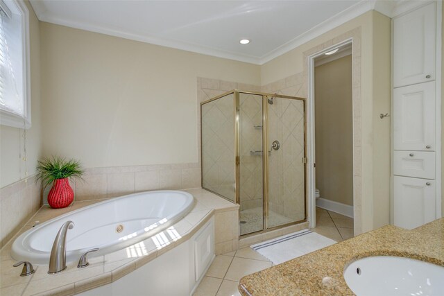 bathroom with a garden tub, tile patterned flooring, a stall shower, and toilet