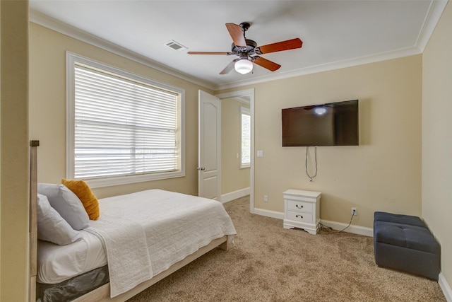 carpeted bedroom with crown molding, baseboards, visible vents, and ceiling fan