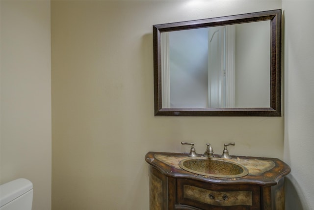 bathroom featuring toilet and vanity