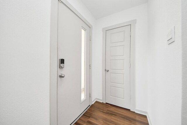 2906 Chase Cross Ln, Houston, TX 77047 - doorway with dark wood-style floors and baseboards