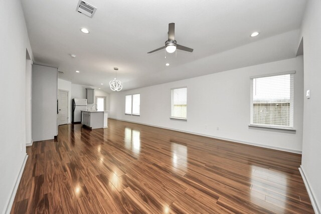 2906 Chase Cross Ln, Houston, TX 77047 - unfurnished living room featuring a ceiling fan, dark wood-style flooring, recessed lighting, a chandelier, and baseboards