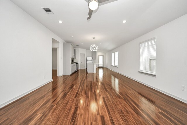 2906 Chase Cross Ln, Houston, TX 77047 - unfurnished living room featuring dark wood-style floors, a ceiling fan, recessed lighting, baseboards, and lofted ceiling