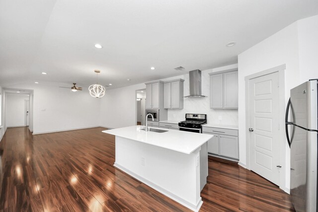 2906 Chase Cross Ln, Houston, TX 77047 - kitchen featuring wall chimney exhaust hood, stainless steel appliances, gray cabinets, a sink, and dark wood-type flooring