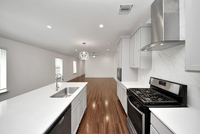 2906 Chase Cross Ln, Houston, TX 77047 - kitchen featuring wall chimney exhaust hood, stainless steel appliances, a sink, light countertops, and recessed lighting